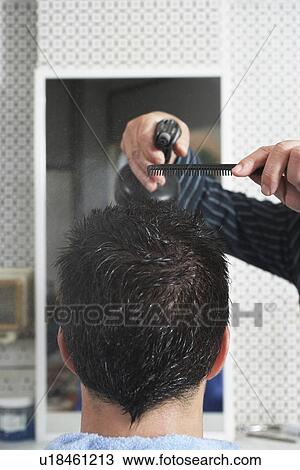 Barber spraying mans hair in barber shop close-up View Large Photo Image Stock Image - Barber spraying mans hair in barber shop close-up. Fotosearch