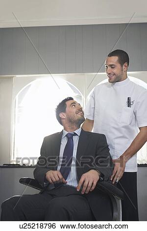 Barber talking to customer in barber shop View Large Photo Image Stock Photograph - Barber talking to customer in barber shop. Fotosearch