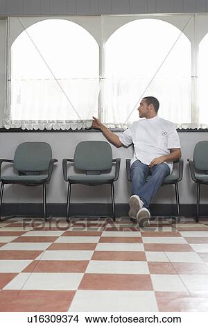Picture - Barber waiting for customers in barber shop. Fotosearch