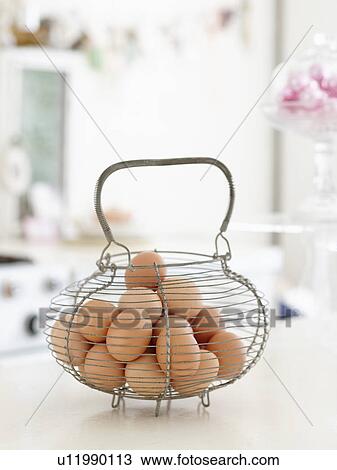 Stock Image - Basket of Brown Eggs on Countertop. Fotosearch