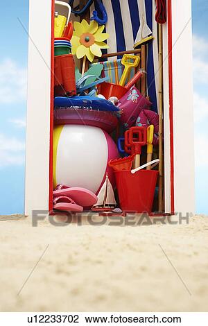 Stock Image - Beach storage cabin with beach toys. Fotosearch