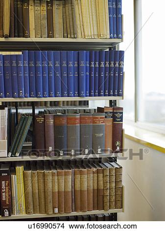 Picture - Books on library shelf. Fotosearch