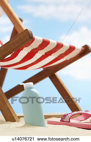 Bottle of cream lotion under deckchair on beach View Large Photo Image Stock Image - Bottle of cream lotion under deckchair on beach. Fotosearch