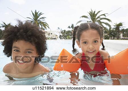 Picture - Boy (5-6 years) and girl (5-6 years) in swimming pool. Fotosearch