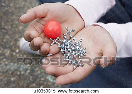Boy (7-9) holding bouncy ball and jacks close-up View Large Photo Image Stock Photography - Boy (7-9) holding bouncy ball and jacks close-up. Fotosearch