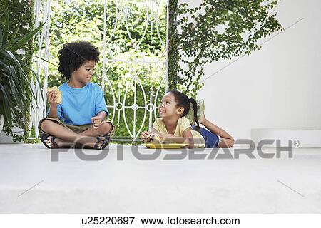 Boy and girl (5-6 years) eating on verandah floor View Large Photo Image Stock Photo - Boy and girl (5-6 years) eating on verandah floor. Fotosearch