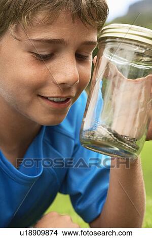 Picture - Boy Looking at Snake in Jar. Fotosearch
