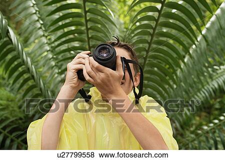Stock Photo - Boy Taking Photos in Forest. Fotosearch