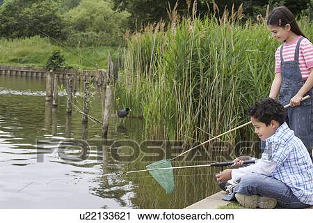 Brother and sister (5-9) fishing in river View Large Photo Image Stock Image - Brother and sister (5-9) fishing in river. Fotosearch