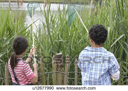 Brother and sister (5-9) with fishing nets at lake View Large Photo Image Stock Image - Brother and sister (5-9) with fishing nets at lake. Fotosearch