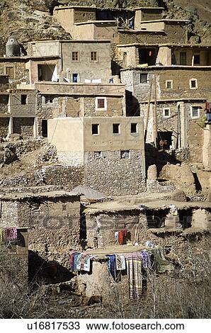 Stock Image - Buildings with hanging laundry on terraced slope. Fotosearch