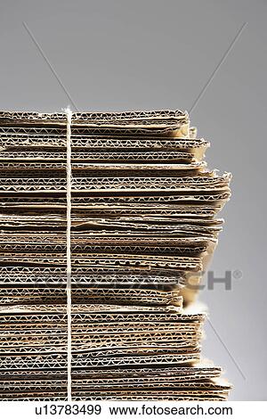 Bundle of waste cardboard tied with string close-up View Large Photo Image Stock Photo - Bundle of waste cardboard tied with string close-up. Fotosearch