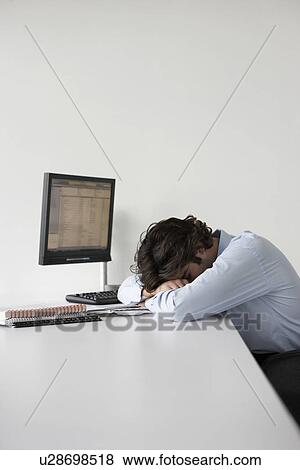 Business man resting head on office desk side view View Large Photo Image Stock Photo - Business man resting head on office desk side view. Fotosearch