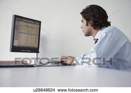 Business man using computer side view View Large Photo Image Picture - Business man using computer side view. Fotosearch