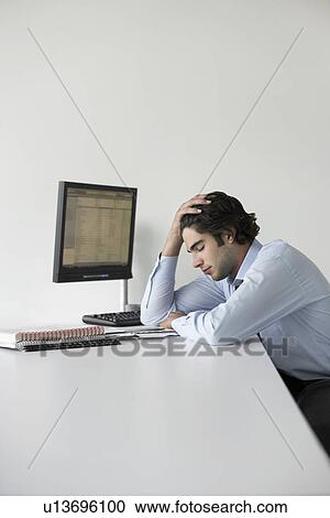 Business man with head in hands sitting in office side view View Large Photo Image Stock Image - Business man with head in hands sitting in office side view. Fotosearch