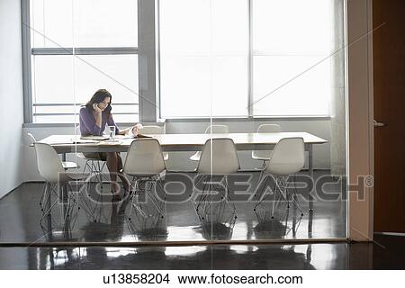 Picture - Business woman sitting in conference room. Fotosearch