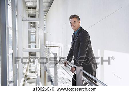 Stock Image - Businessman in modern building portrait. Fotosearch