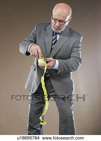 Businessman Peeling Apple View Large Photo Image Picture - Businessman Peeling Apple. Fotosearch