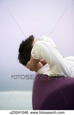 Businessman reclining hands on neck on sofa side view View Large Photo Image Stock Photo - Businessman reclining hands on neck on sofa side view. Fotosearch