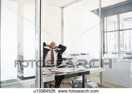 Businessman Relaxing in Office. View Large Photo Image Stock Photograph - Businessman Relaxing in Office.. Fotosearch