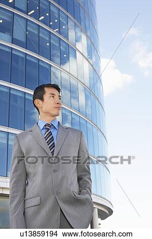Businessman standing hands in pocket Outside Office Building View Large Photo Image Picture - Businessman standing hands in pocket Outside Office Building. Fotosearch