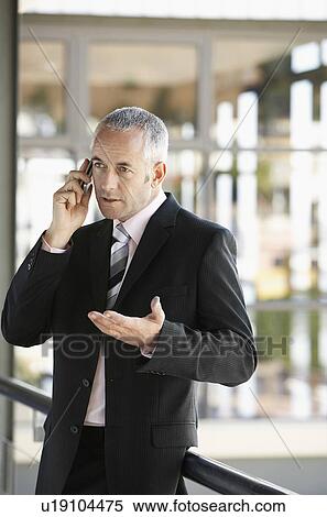 Stock Photography - Businessman talking on mobile phone.. Fotosearch