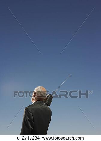 Businessman Under Clear Sky Listening to Radio View Large Photo Image Picture - Businessman Under Clear Sky Listening to Radio. Fotosearch