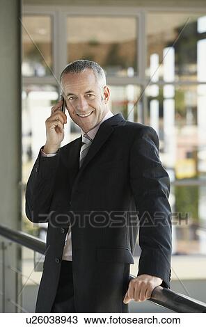 Stock Image - Businessman using mobile phone.. Fotosearch