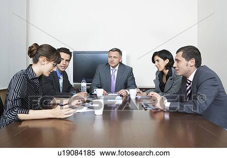 Stock Photography - Businesspeople having meeting in office. Fotosearch