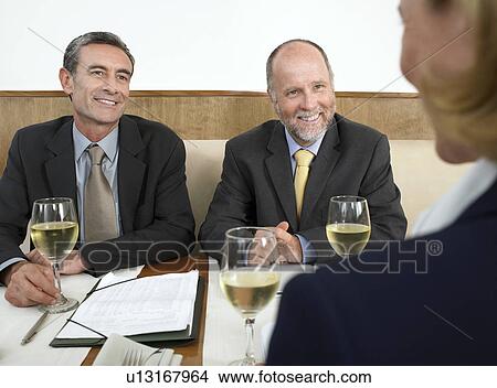 Businesspeople having meeting in restaurant View Large Photo Image Picture - Businesspeople having meeting in restaurant. Fotosearch