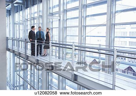 Businesspeople in modern building View Large Photo Image Stock Photo - Businesspeople in modern building. Fotosearch