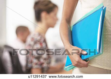 Businesswoman carrying Folder mid section close-up View Large Photo Image Stock Photo - Businesswoman carrying Folder mid section close-up. Fotosearch