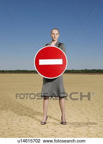 Businesswoman holding 'no entry' sign in desert full length View Large Photo Image Stock Image - Businesswoman holding 'no entry' sign in desert full length. Fotosearch