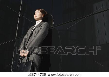 Businesswoman Leaning eyes closed Against Wall outside View Large Photo Image Stock Photograph - Businesswoman Leaning eyes closed Against Wall outside. Fotosearch