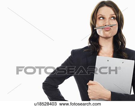 Businesswoman pulling funny face with pen View Large Photo Image Stock Image - Businesswoman pulling funny face with pen. Fotosearch