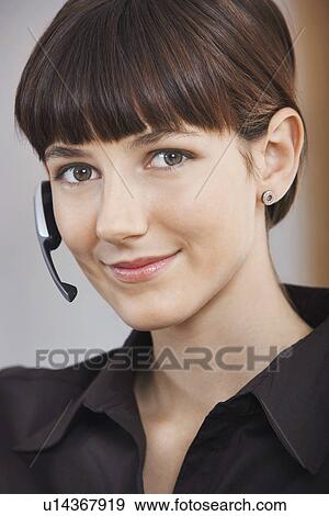 Stock Photo - Businesswoman wearing telephone headset portrait. Fotosearch