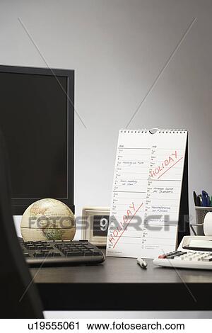 Calendar with marked holiday time on desk in office View Large Photo Image Stock Image - Calendar with marked holiday time on desk in office. Fotosearch