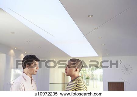 Casually dressed Businessmen Talking in Office side view View Large Photo Image Stock Photography - Casually dressed Businessmen Talking in Office side view. Fotosearch