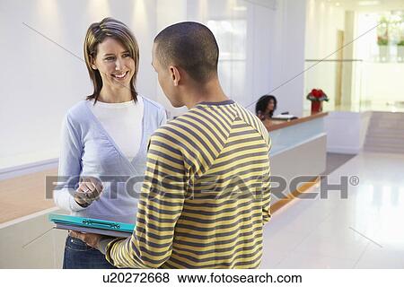 Casually dressed Businesspeople Talking in Office View Large Photo Image Stock Photo - Casually dressed Businesspeople Talking in Office. Fotosearch