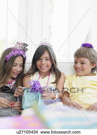 Picture - Children (7-12) at birthday party smiling. Fotosearch