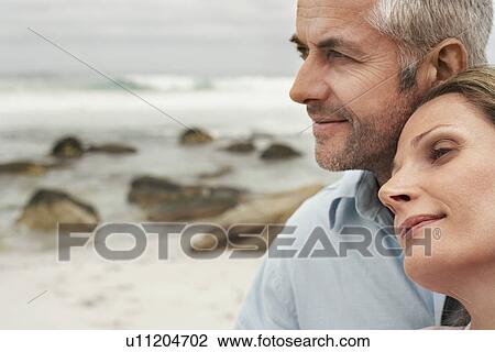 Close up of couple on beach woman resting her head on man's shoulder View Large Photo Image Stock Image - Close up of couple on beach woman resting her head on man's shoulder. Fotosearch