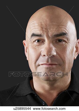Close-up portrait of mature man with bald head against black background View Large Photo Image Picture - Close-up portrait of mature man with bald head against black background. Fotosearch
