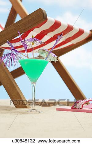 Stock Image - Coctail next deckchair on beach. Fotosearch