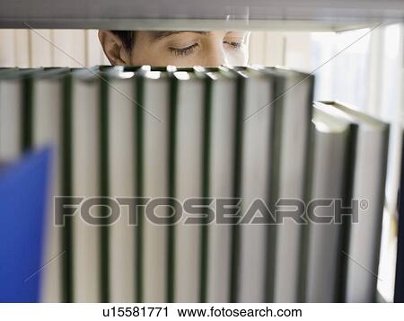 Stock Image - College Student Reading in Library. Fotosearch