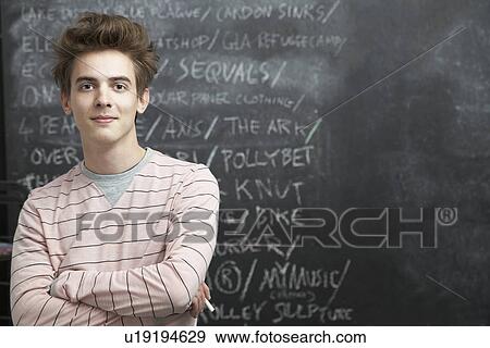 Stock Photo - College Student Writing on Blackboard. Fotosearch
