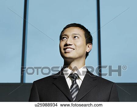 Confident Businessman looking up low angle view View Large Photo Image Picture - Confident Businessman looking up low angle view. Fotosearch