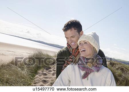 Stock Image - Couple at ocean smiling. Fotosearch