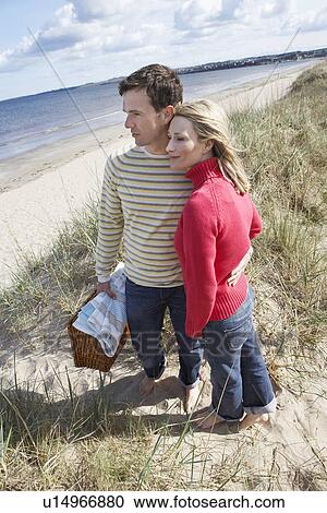Couple embracing at beach View Large Photo Image Stock Image - Couple embracing at beach. Fotosearch