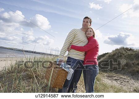Couple embracing at beach View Large Photo Image Stock Photo - Couple embracing at beach. Fotosearch