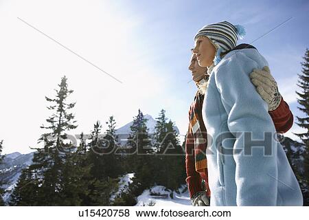 Couple embracing in mountains side view low angle view View Large Photo Image Stock Photo - Couple embracing in mountains side view low angle view. Fotosearch